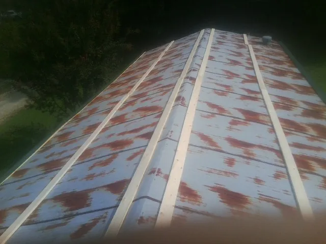 Rusted metal roof panels with new wood purlins before replacement — Storm Damage Roof Repair in New Cumberland by Roofing Brothers