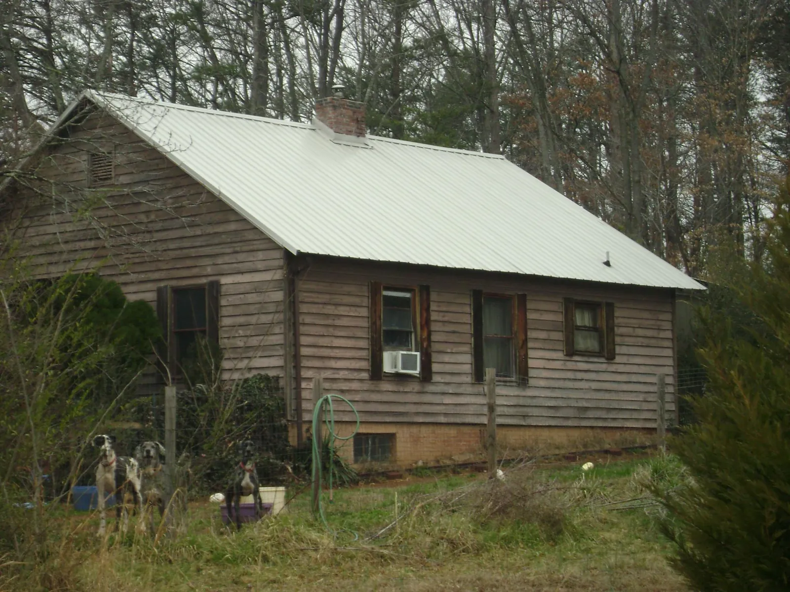 White metal roof on an old wood sided farmhouse, from a Metal Roof Installation job in New Cumberland